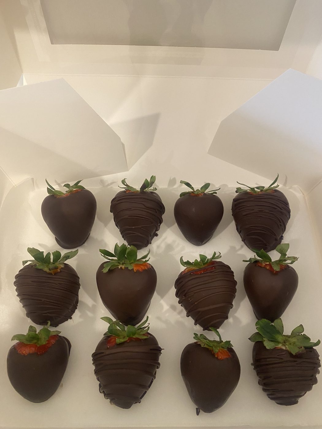 Dark chocolate coated strawberries in a gift box for a wedding dessert table