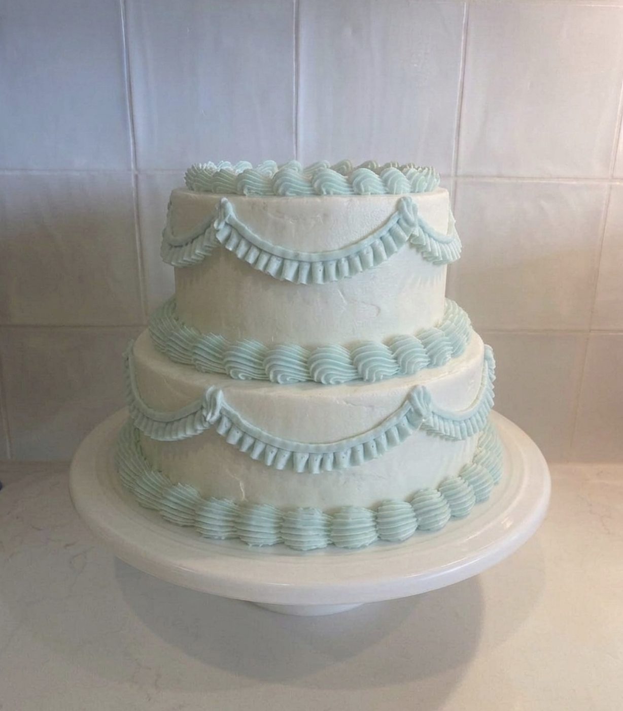 Three-tier white wedding cake with teal piping by Sweet Highland Bakes, Southern Highlands